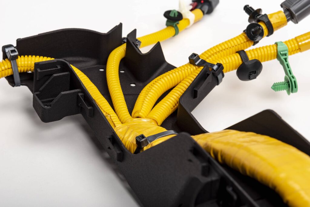 Exposed yellow cables in black cable organizer