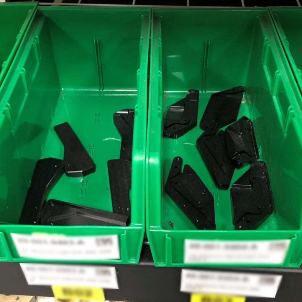 Plastic parts in green boxes